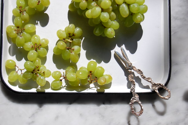 green grape clusters with scissors