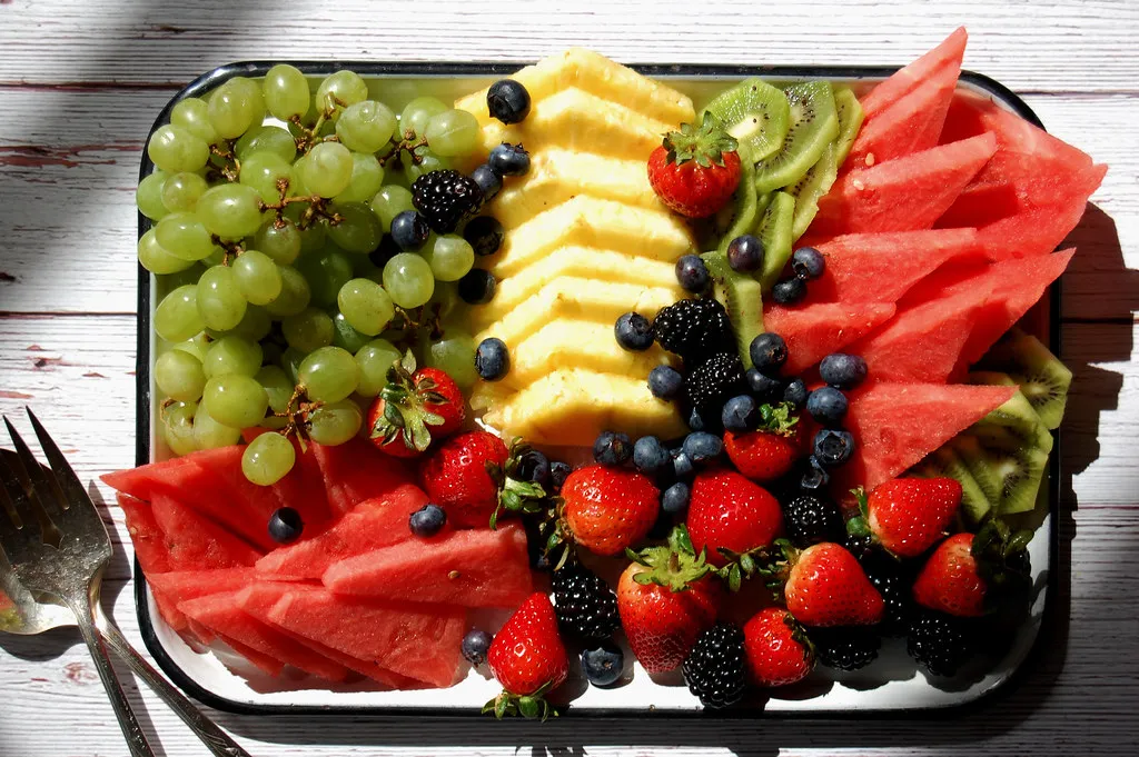 Cutting melon for a fruit deals tray