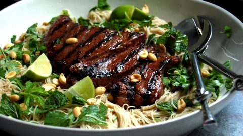 grilled flank steak on bed or rice noodles with herbs
