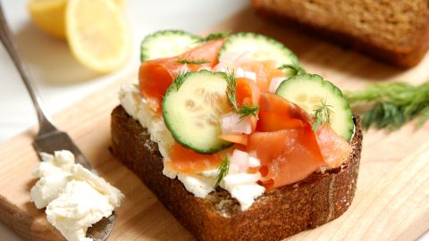 cured cured salmon cucumber smorrebrod toast on wooden board with garnishes cucumber smorrebrod toast on wooden board with garmishes