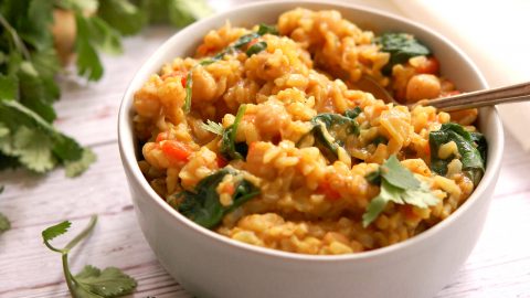 bowl of vegetarian Ayurvedic kitchari with cilantro and spinach on top for dinner
