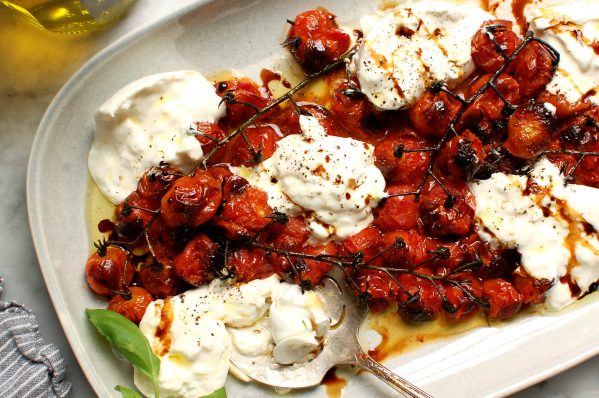 creamy burrata caprese salad recipe on platter