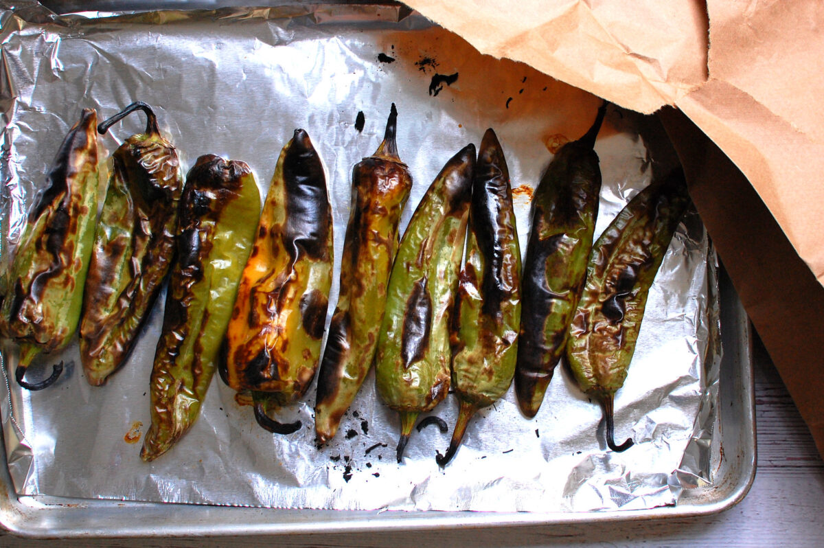 broiled green chiles ready to peel and dice for green chile cheeseburgers