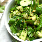 bowl of spicy Asian cucumber salad with herbs