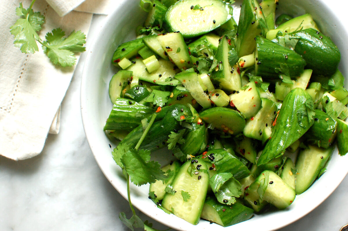 bowl of spicy Asian cucumber salad with herbs