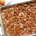 toasted pecans on baking sheet before adding to pecan chocolate chip pie filling ingredients