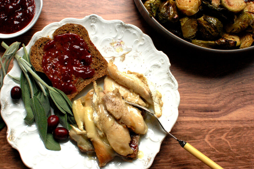 Ultimate Leftover Turkey Melt sandwich with oozing melted Brie cheese, a thick layer of cranberry sauce, and toasted bread.