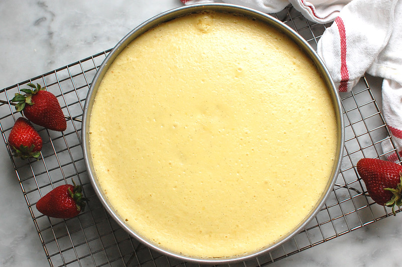 baked cheesecake cooling on wire cooling rack