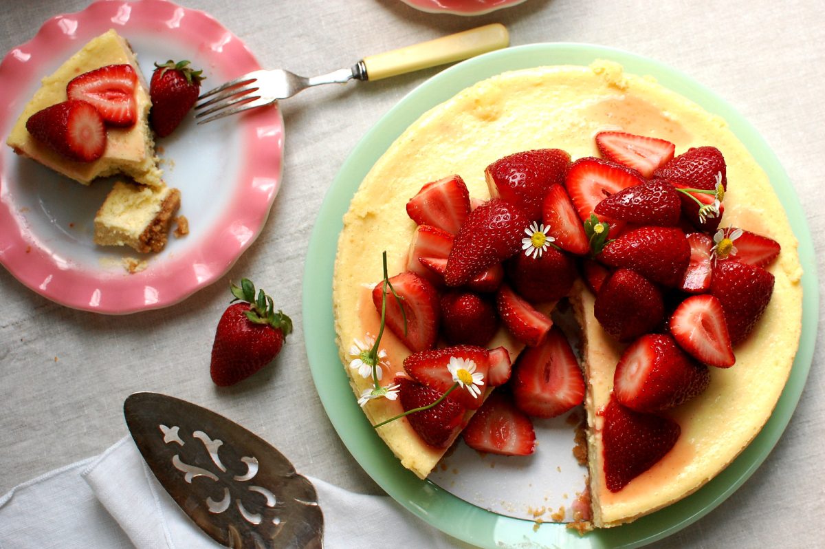 sliced strawberry cheesecake with graham cracker crust