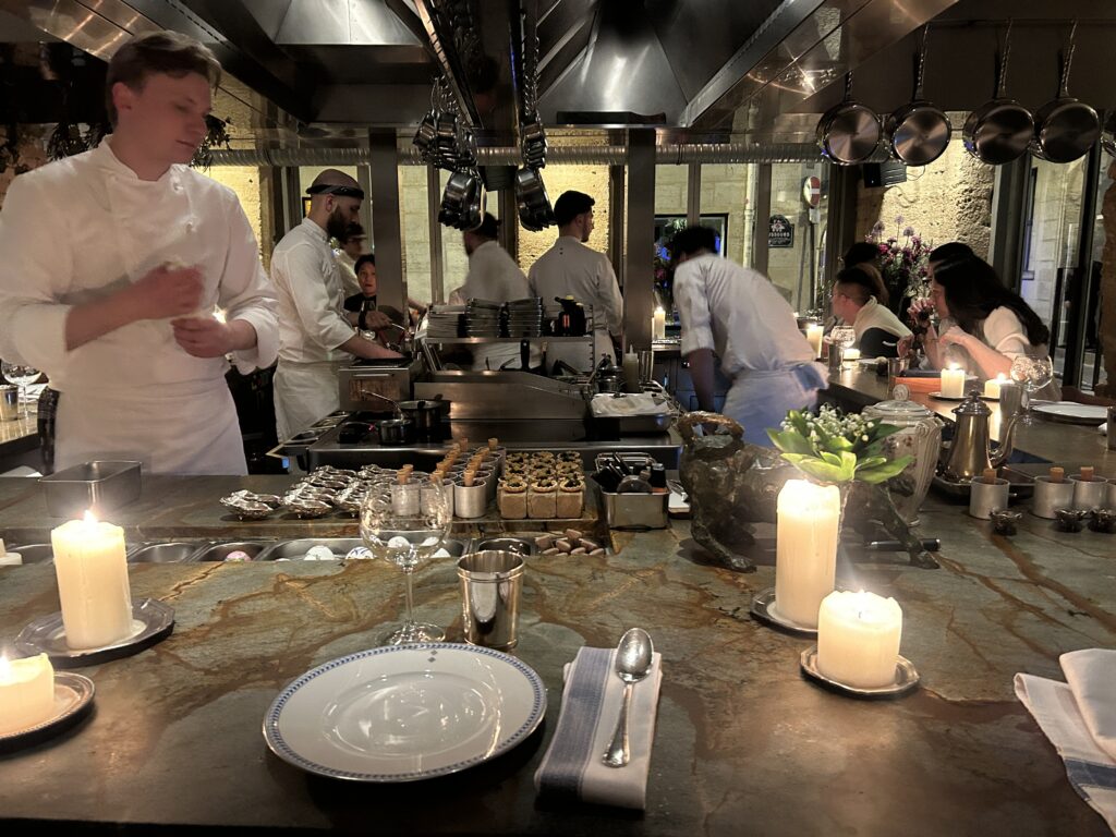 chefs preparing food in the open kitchen of the best restaurant in Paris 2026 Shabour