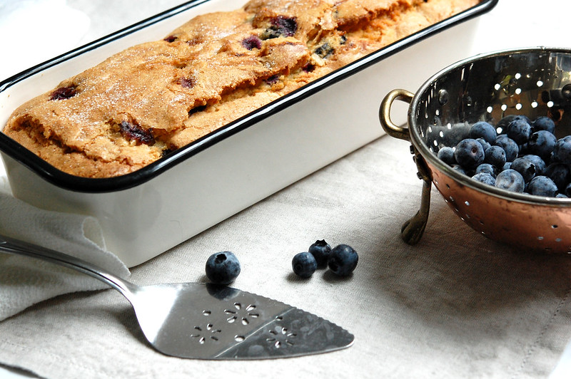 baked blueberry pound cake in loaf pan with fresh blueberries