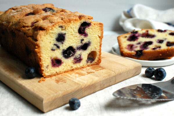 Classic blueberry pound cake, sliced, showing a recipe with a moist crumb studded with juicy blueberries