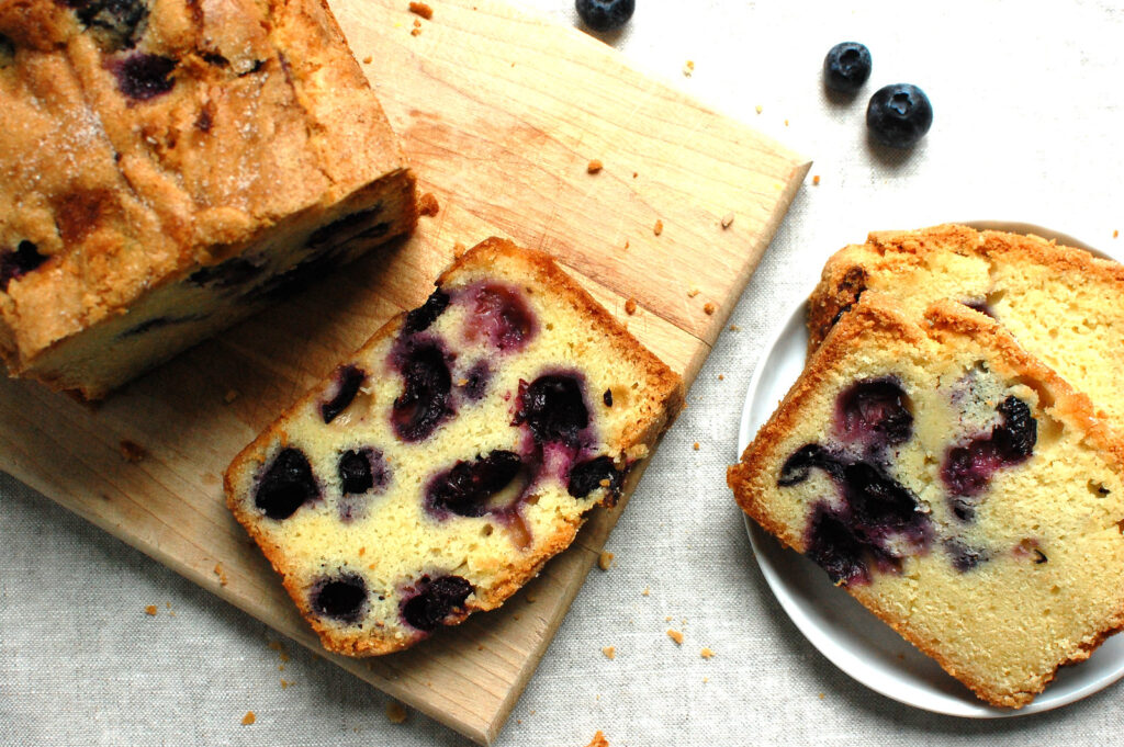 Baked blueberry pound cake cooling on a wire rack before glazing