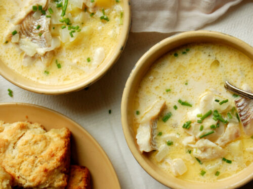 authentic New England fish chowder recipe with haddock, potatoes, and chives in bowls