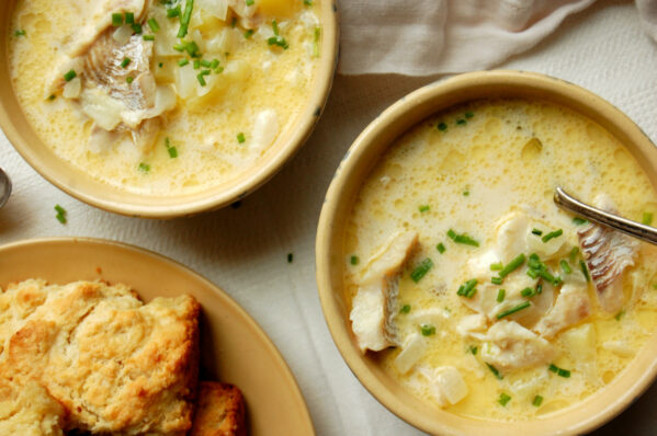 authentic New England fish chowder recipe with haddock, potatoes, and chives in bowls