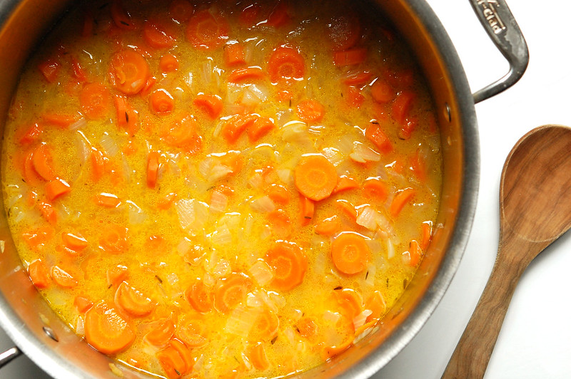 carrots in soup pot with broth