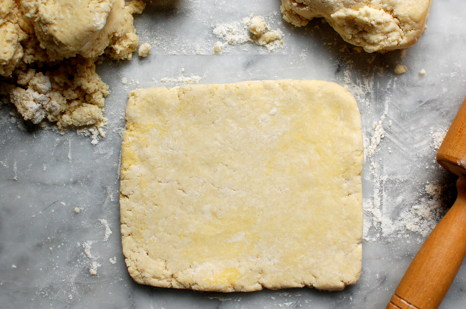 Rolled-out cream cheese rugelach dough disc chilled on counter ready for filling to be added.
