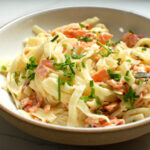 Creamy Smoked Salmon Pasta with chives and lemon zest in pasta bowl ready to serve for dinner