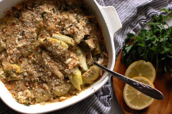 Italian artichoke casserole in a white baking dish with golden breadcrumb topping