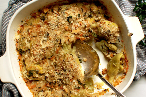 Italian artichoke casserole in a white baking dish with golden breadcrumb topping