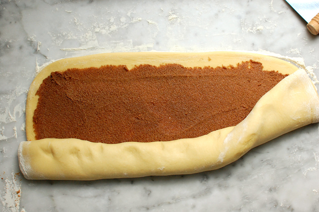 rolling cinnamon buns into a log