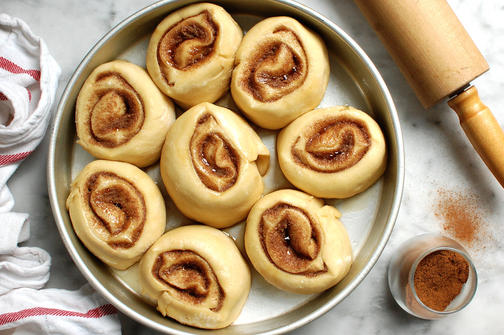 cinnamon rolls in cake pan after rising, before baking