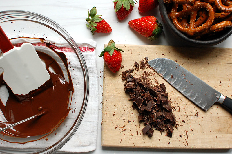 preparing melted chocolate to dip in pretzels