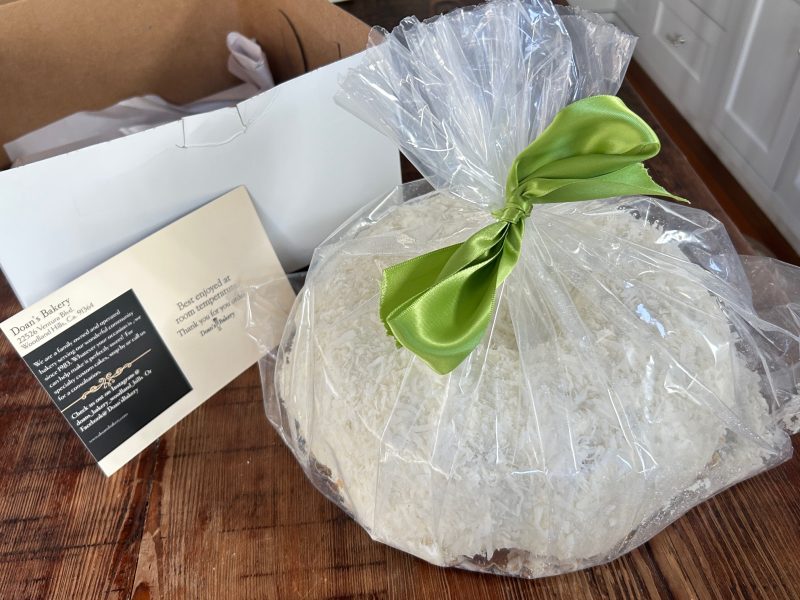 authentic Doan's Bakery white chocolate coconut bundt cake in original delivery box and packaging.