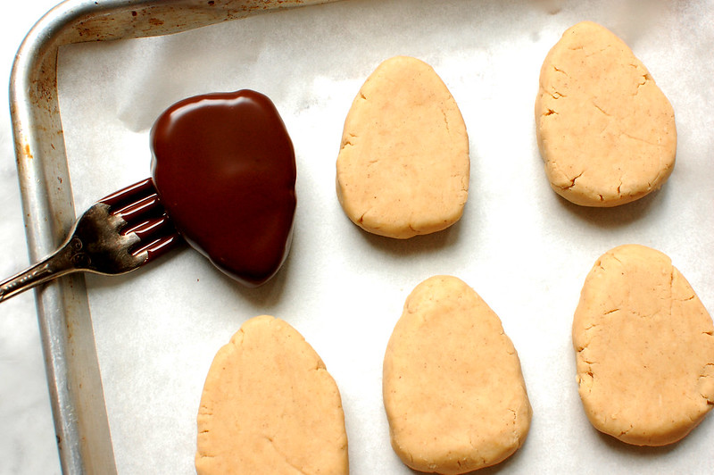 dipping peanut butter eggs in chocolate with fork