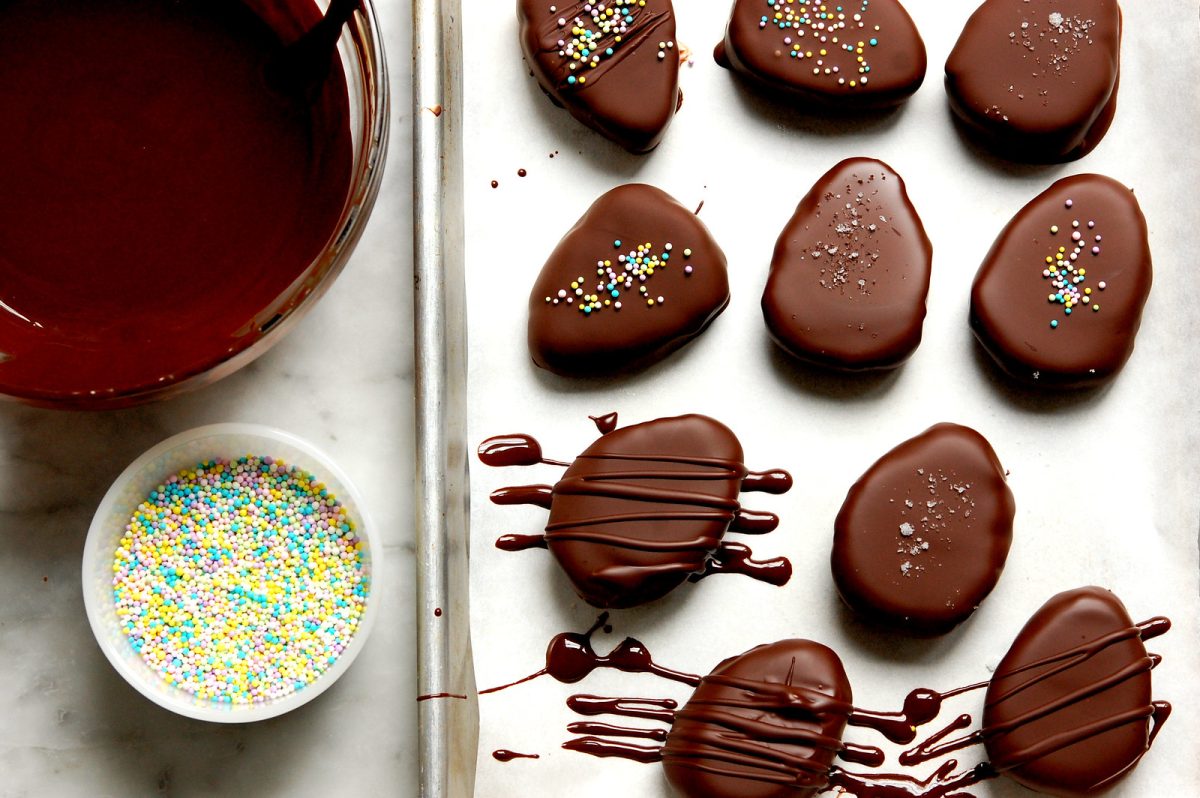 chocolate-dipped peanut butter eggs on sheet pan with decoration