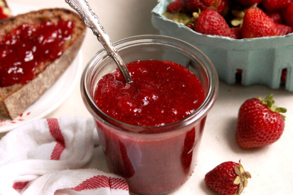 A jar of chunky homemade strawberry preserves made with 3 ingredients and no pectin