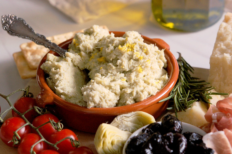 artichoke spread served on charcuterie board