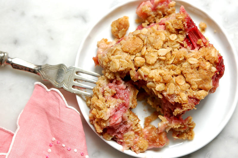 baked strawberry rhubarb crumb bar wedge on plate