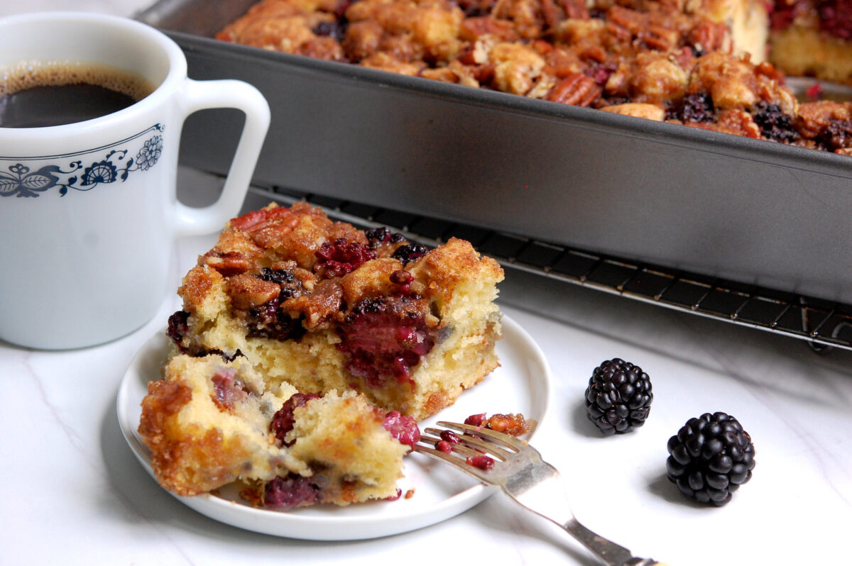 piece of homemade blackberry coffee cake with coffee and fork