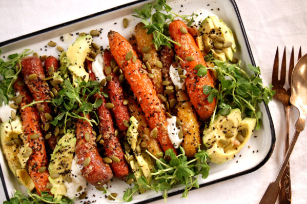 roasted carrot dish on sheet pan with fresh herb garnish