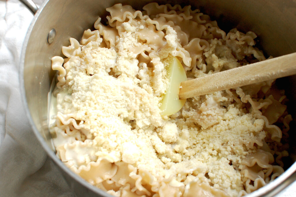 Pasta tossed in creamy gorgonzola sauce in a bowl with spoon.