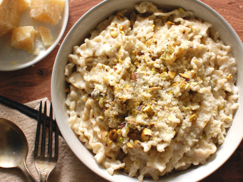 Creamy gorgonzola pasta in a wide bowl topped with toasted pistachios and Parmesan
