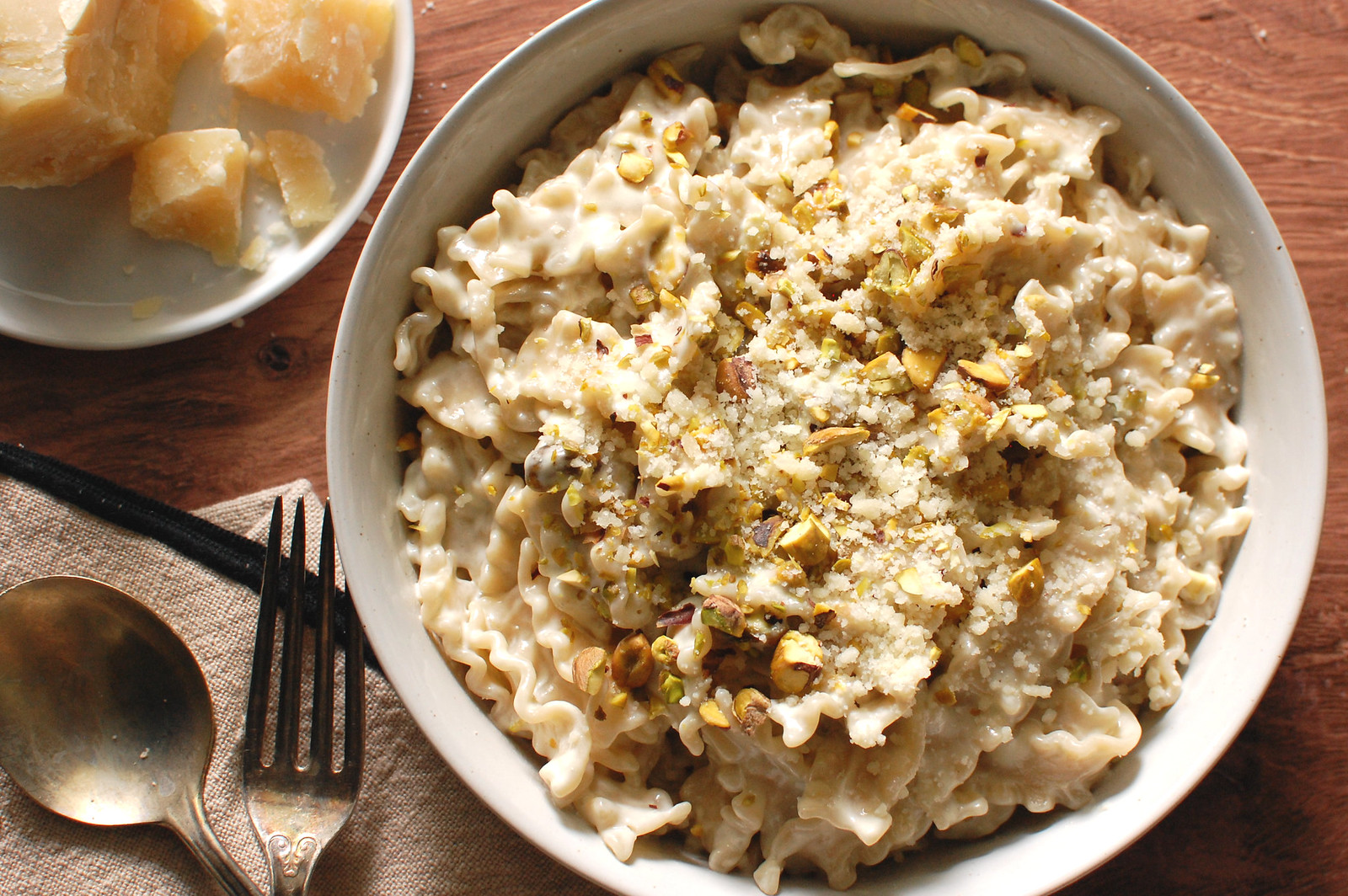 Creamy gorgonzola pasta in a wide bowl topped with toasted pistachios and Parmesan