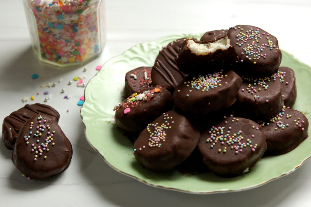 Decorated coconut cream Easter eggs with chocolate coating and sprinkles on fancy serving plate ready to eat