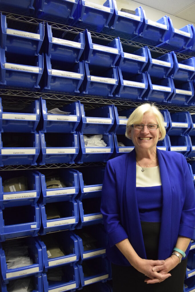 Vickie Kloeris NASA food scientist posing with space food packets